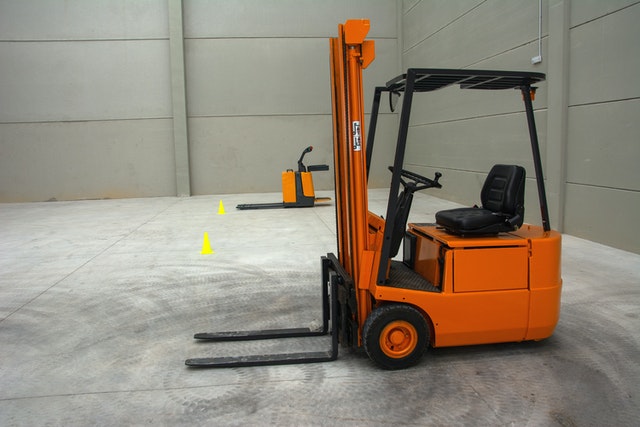 Parked orange forklift to be diagnosed for repairs